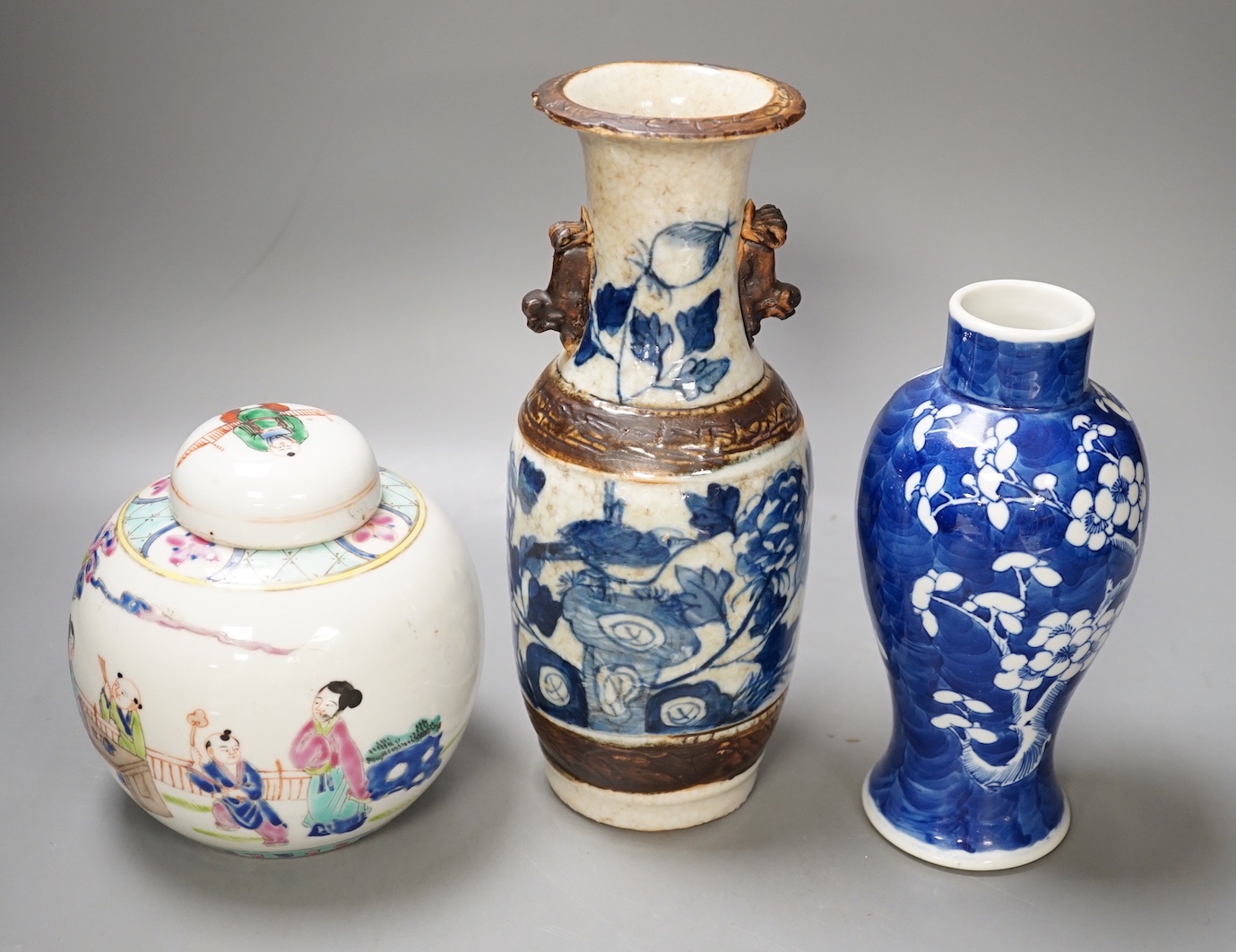 A 19th century Chinese blue and white prunus jar, a crackle glaze vase and a famille rose jar and cover